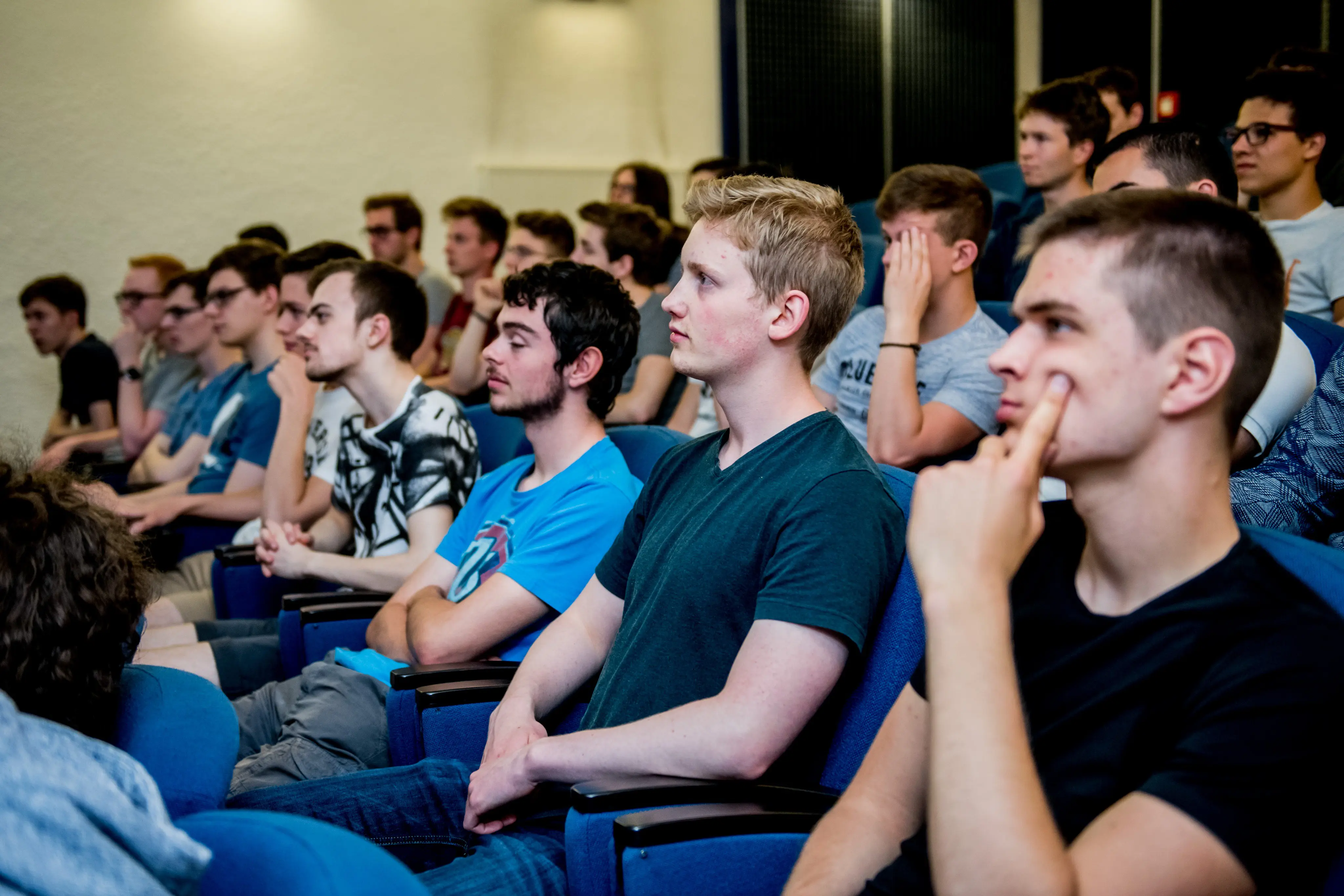 An auditorium filled with students, listening to the results