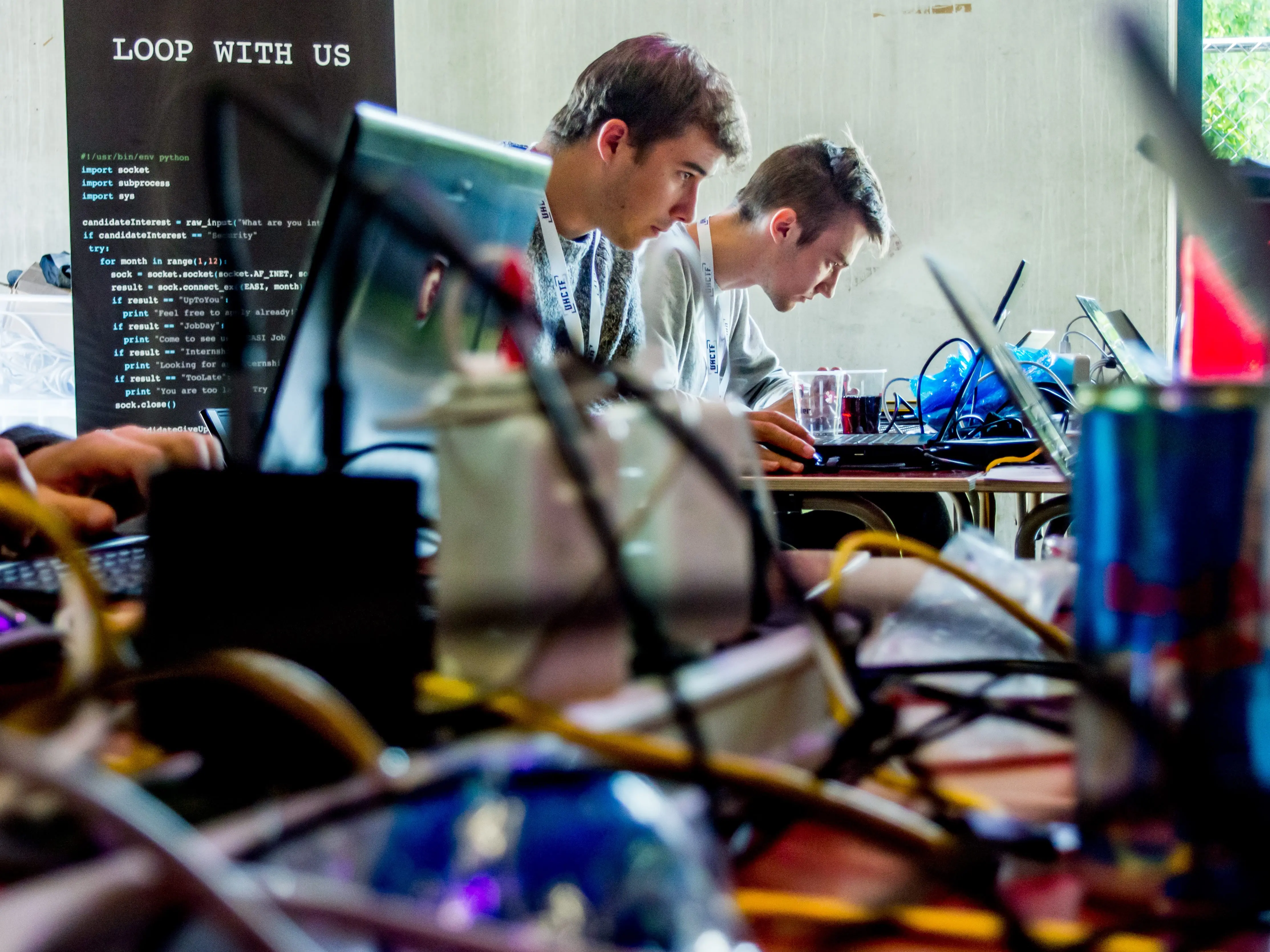 Students working in front of a banner of a sponsor